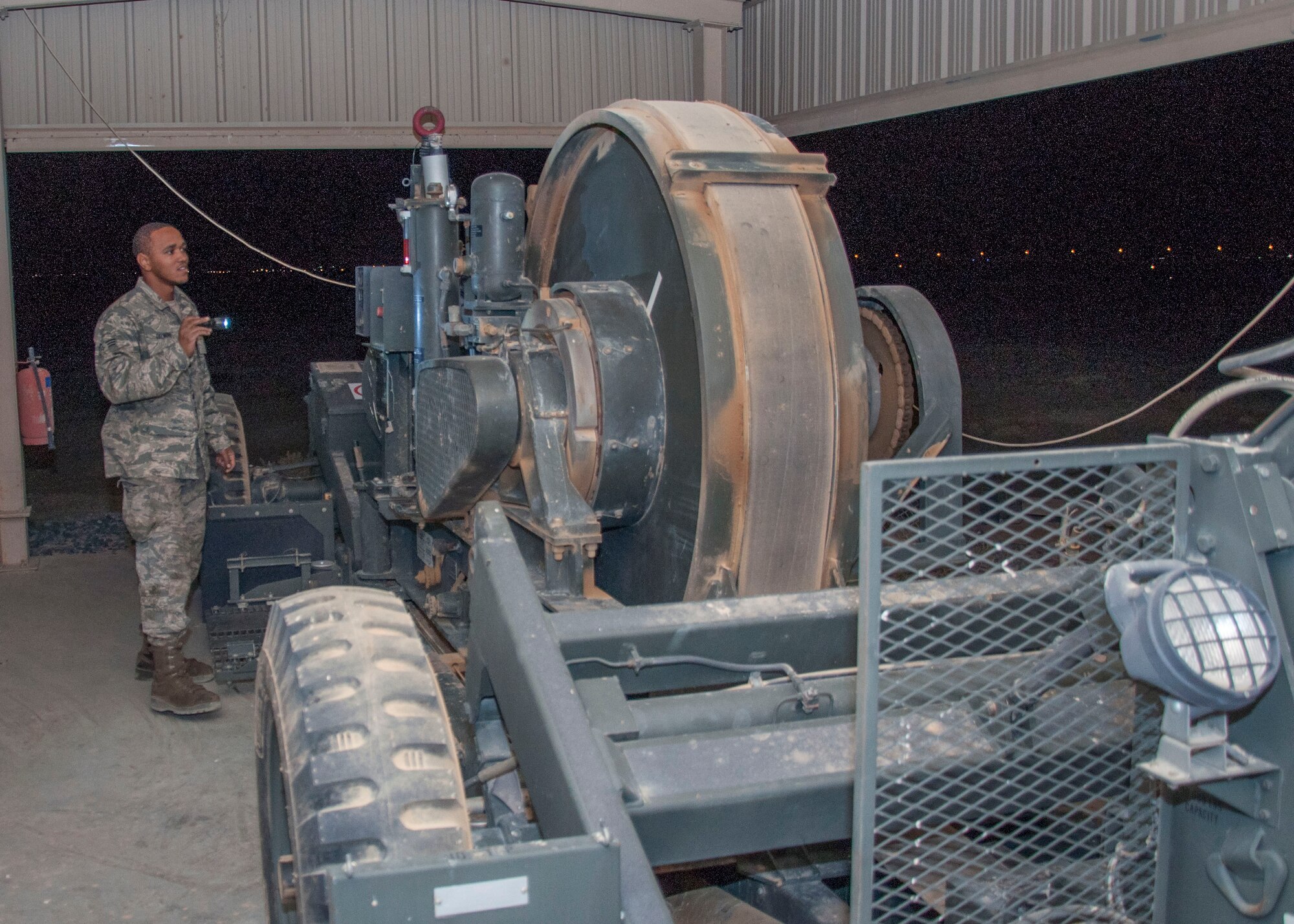 Senior Airman Quentin Palmore, a power production specialist assigned to the 386th Expeditionary Civil Engineer Squadron, conducts and inspection on a mobile aircraft arresting system at an undisclosed location in southwest Asia, June 24, 2017. A visual inspection is performed on these units daily. (U.S. Air Force Photo by Master Sgt. Eric M. Sharman)