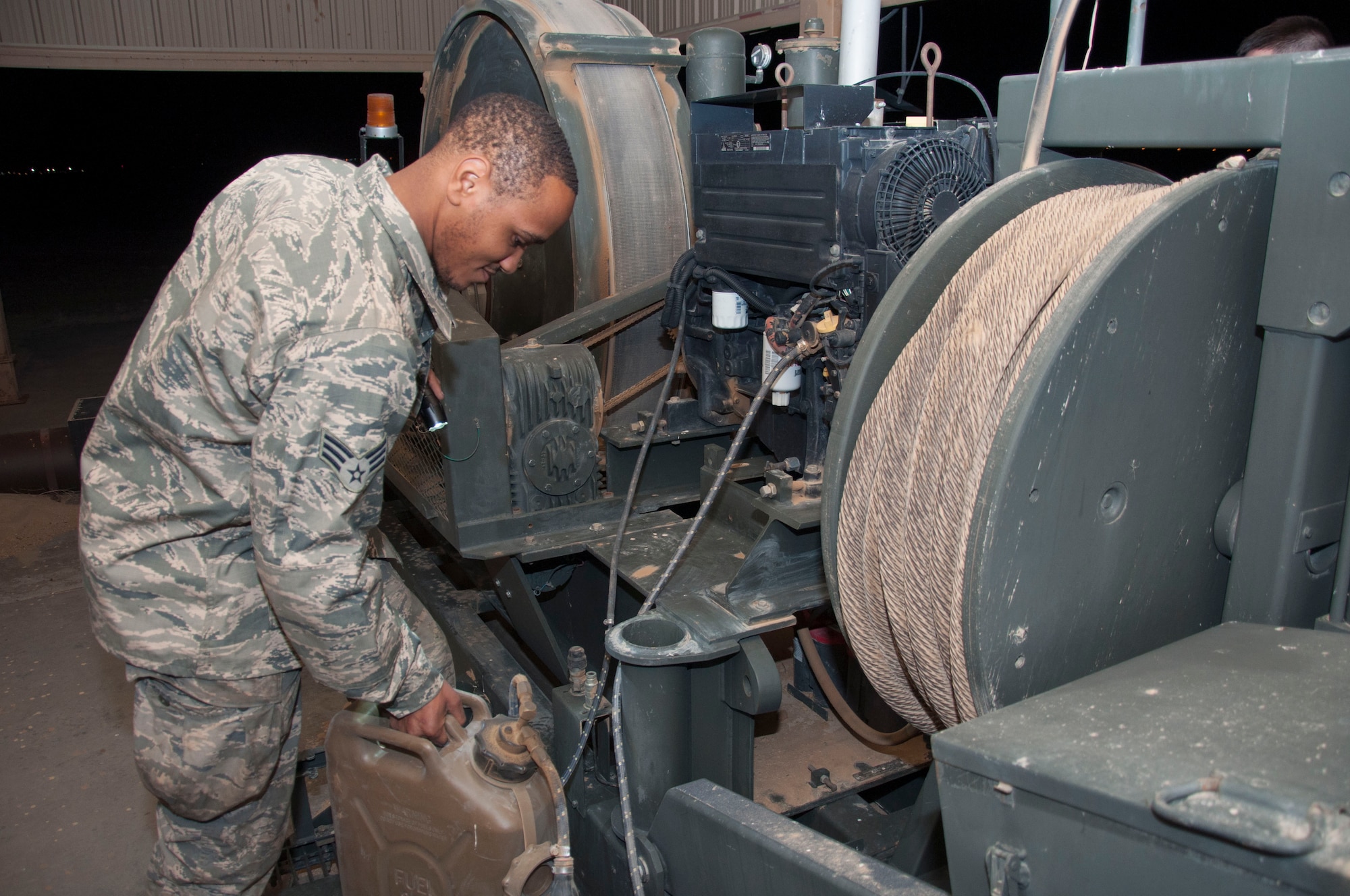 Senior Airman Quentin Palmore, a power production specialist assigned to the 386th Expeditionary Civil Engineer Squadron, conducts and inspection on a mobile aircraft arresting system at an undisclosed location in southwest Asia, June 24, 2017. A visual inspection is performed on these units daily. (U.S. Air Force Photo/Master Sgt. Eric M. Sharman)
