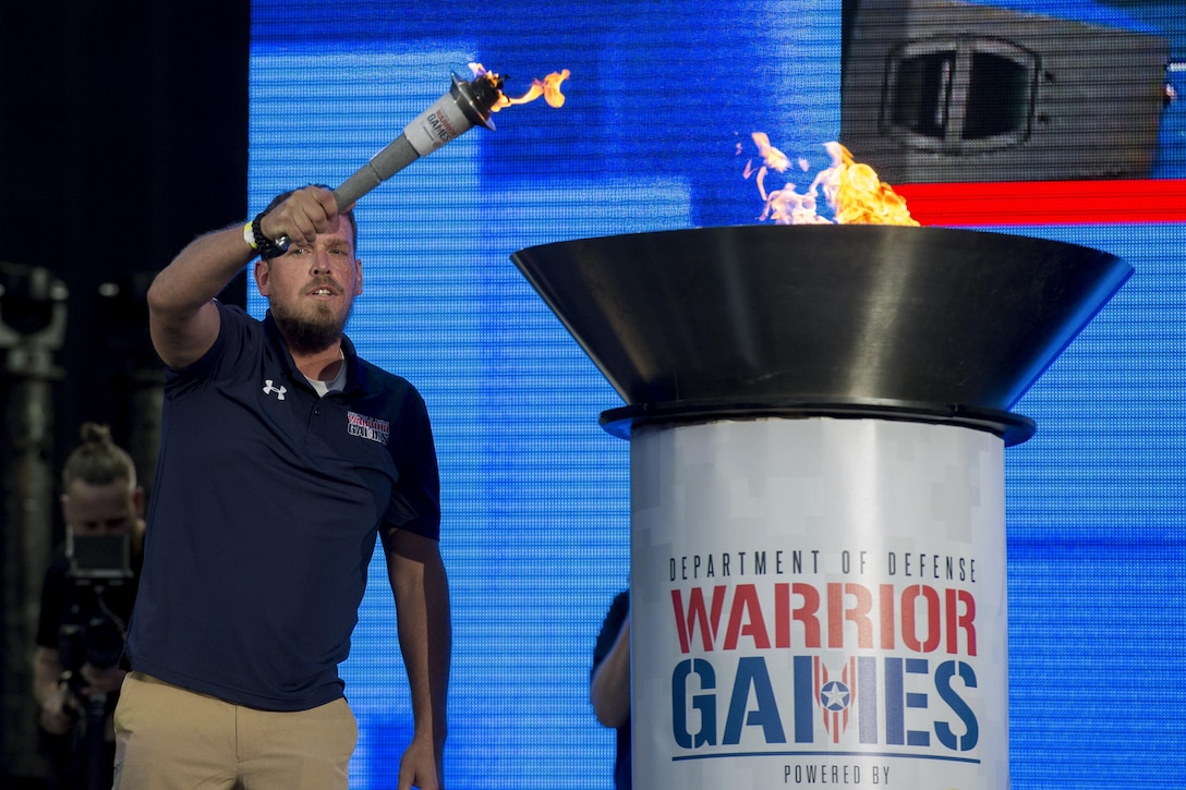 Retired Navy Petty Officer 3rd Class Nate Hamilton lights the torch officially kicking off the 2017 Department of Defense Warrior Games at Soldier Field in Chicago, July 1, 2017. DoD photo by EJ Hersom