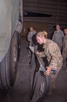 Airman Kiley Foulke, a 386th Expeditionary Maintenance Squadron combat metals team member, inspects the edge of a recently repaired C-130 Hercules landing gear door during an installation operation at an undisclosed location in Southwest Asia, June 23, 2017. (U.S. Air Force photo/Master Sgt. Eric M. Sharman)