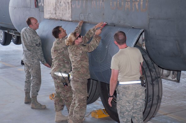 The 386th Expeditionary Maintenance Squadron combat metals team installs a repaired C-130 Hercules landing gear door during a maintenance operation at an undisclosed location in Southwest Asia, June 23, 2017. (U.S. Air Force photo/Master Sgt. Eric M. Sharman)