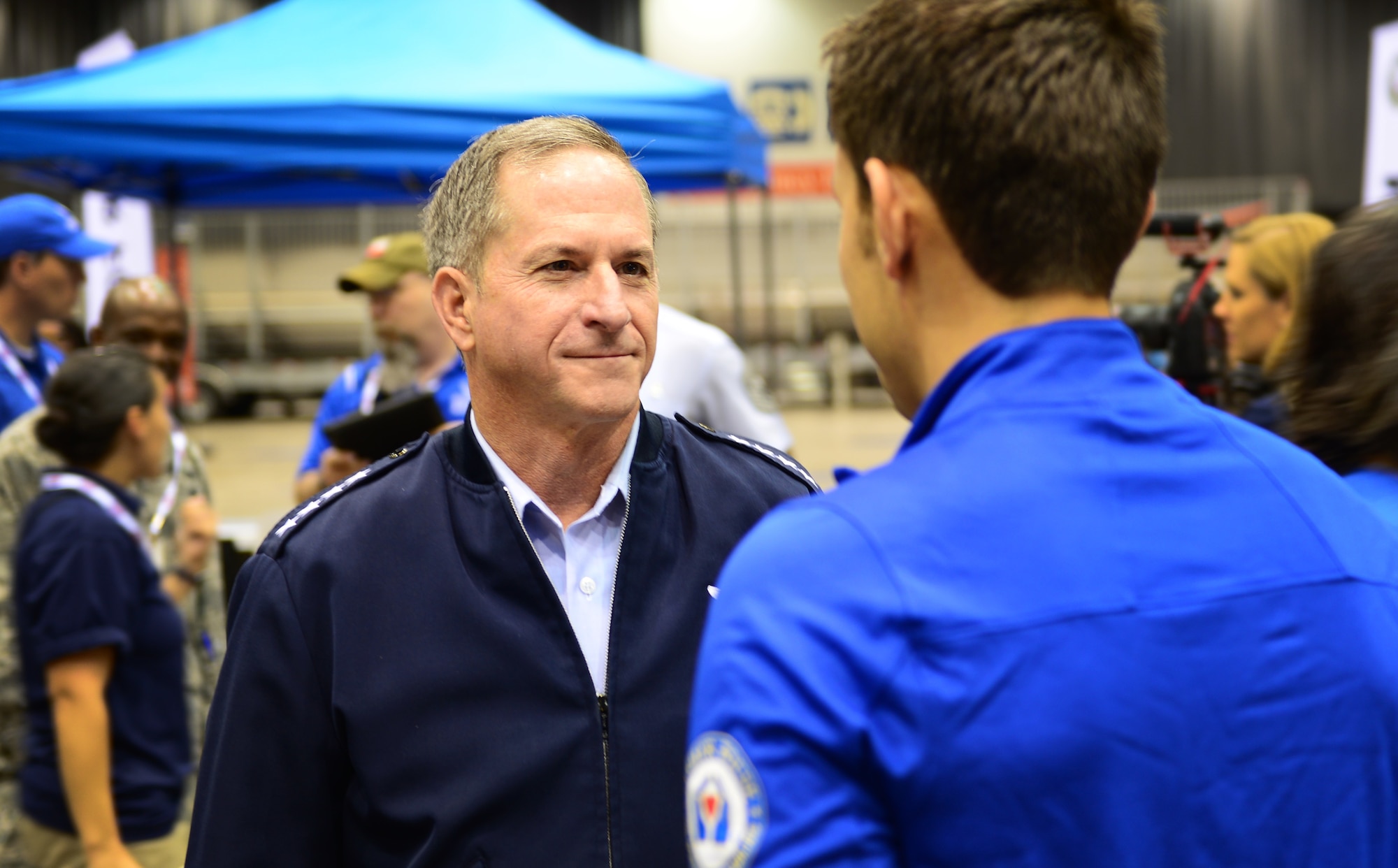 Air Force Chief of Staff Gen. David Goldfein speaks with Master Sgt. Kenneth Guinn, an explosive ordnance disposal troop from Sunray, Texas, at the 2017 Warrior Games July 1, 2017, at McCormick Place-Lakeside Center in Chicago. Goldfein and other members of senior leadership traveled to Chicago for the official opening ceremonies of this year’s games to demonstrate their commitment and support for all Team Air Force wounded warriors. (U.S. Air Force photo/Staff Sgt. Chip Pons)