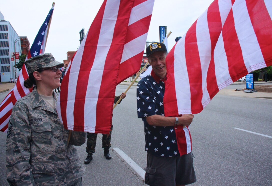Master Sgt. Karen Ridge with the 932nd Aeromedical Evacuation Squadron, shares a laugh with retired public affairs specialist Tech. Sgt. Daniel Oliver, as they remember fond wing memories before the start of the big America's Birthday VP parade on July 1, 2017, in Saint Louis, Missouri.  Volunteers of the 932nd Airlift Wing gave of their time to think of the history of America's Independence Day, and consider other military veterans who went before them, and sometimes gave the ultimate sacrifice of their lives. 932nd AW members and a few retirees worked together last week to fold the American flag back into its proper position at the end of their parade route. The 932nd Airlift Wing had a great group of enthusiastic volunteers who carried the Air Force Reserve Command banner and represented the unit in the popular Saint Louis parade which was televised live on local networks. The wing plans to help in the Veterans Day parade in November also.
(U.S. Air Force photo by Lt. Col. Stan Paregien)