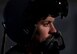A U.S. Air Force pilot with the 332nd Air Expeditionary Wing, demonstrates the headgear aircrew must wear while flying June 13, 2017, in Southwest Asia. The Belgian Medical Component treated aircrew from the 332nd AEW for pains associated with flying high performance aircraft and weight from the equipment they carry. (U.S. Air Force photo/Senior Airman Damon Kasberg)