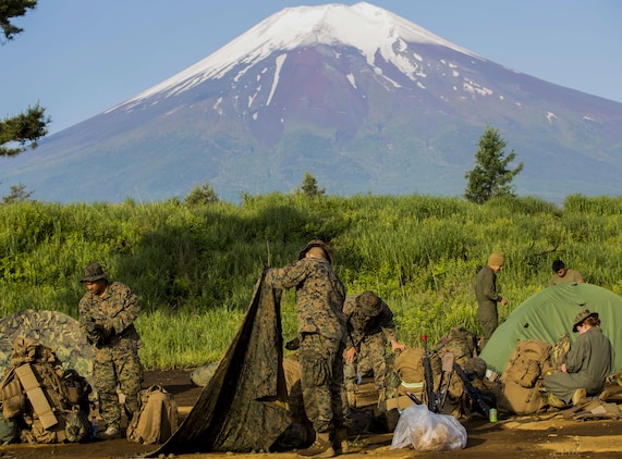 U.S. Marines attached to Marine Wing Support Squadron (MWSS) 171, based out of Marine Corps Air Station Iwakuni, break down their tents during exercise Eagle Wrath 2017 at Combined Arms Training Center Camp Fuji, Japan, June 19, 2017. Forward operating bases and forward arming and refueling points were established during the two-week exercise to train the Marines to provide explosives, weaponry, fuel, security, logistics and personnel to a forward line of troops and aircraft. (U.S. Marine Corps photo by Lance Cpl. Stephen Campbell)