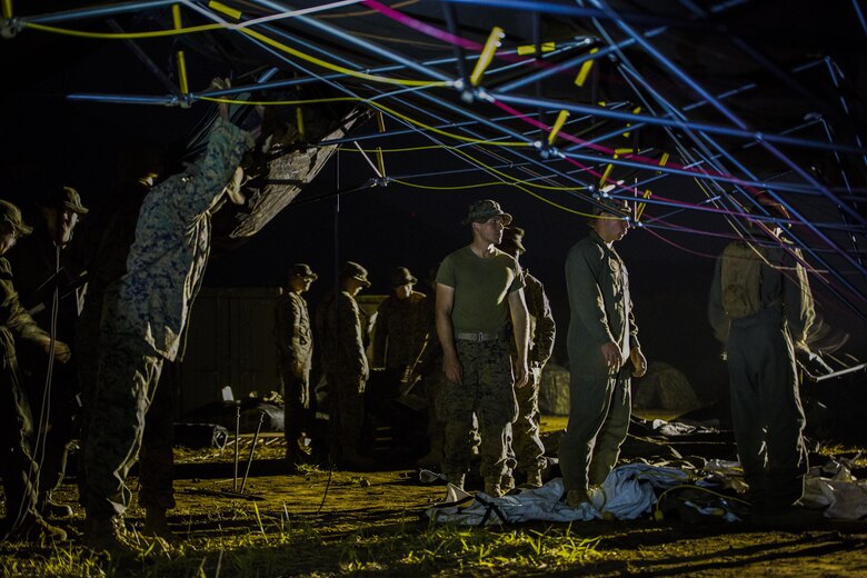 U.S. Marines attached to Marine Wing Support Squadron (MWSS) 171, based out of Marine Corps Air Station Iwakuni, break down a large tent as they prepare to move to a new location during exercise Eagle Wrath 2017 at Combined Arms Training Center Camp Fuji, Japan, June 19, 2017. Forward operating bases and forward arming and refueling points were established during the two-week exercise to train the Marines to provide explosives, weaponry, fuel, security, logistics and personnel to a forward line of troops and aircraft. (U.S. Marine Corps photo by Lance Cpl. Stephen Campbell)