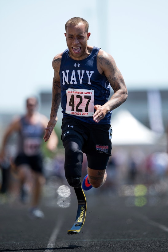 Navy Petty Officer 2nd Class Alan Thomas cross the finish line of the 100 meter dash during the 2017 Department of Defense Warrior Games at Lane Technical College Preparatory High School in Chicago, July 2, 2017. DoD photo by EJ Hersom