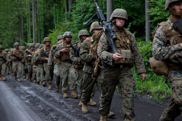 U.S. Marines attached to Marine Wing Support Squadron (MWSS) 171, based out of Marine Corps Air Station Iwakuni, hike back to base after completing exercise Eagle Wrath 2017 at Combined Arms Training Center Camp Fuji, Japan, June 26, 2017. Forward operating bases and forward arming and refueling points were established during the two-week exercise to train the Marines to provide explosives, weaponry, fuel, security, logistics and personnel to a forward line of troops and aircraft. The squadron is set to begin their annual weapons training on July 3, which will include training with M240B light machine guns, hand grenades, M203 grenade launchers, MK19 grenade launchers and AT-4 rocket launchers and will conclude their month-long training. (U.S. Marine Corps photo by Lance Cpl. Stephen Campbell)