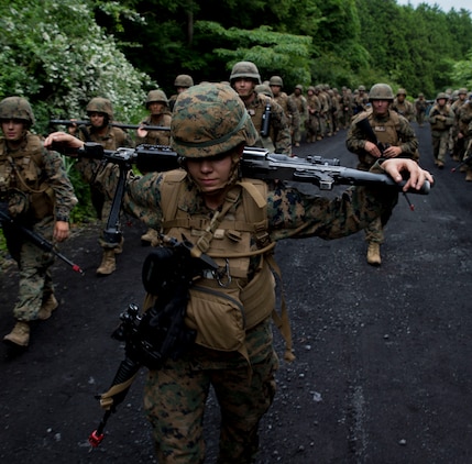 U.S. Marine Corps 2nd Lt. Kirstin Spann, the adjutant attached to Marine Wing Support Squadron (MWSS) 171, based out of Marine Corps Air Station Iwakuni, carries an M240B light machine gun and an M4 Carbine service rifle during the hike back to base after completing Exercise Eagle Wrath 2017 at Combined Arms Training Center Camp Fuji, Japan, June 26, 2017. Forward operating bases and forward arming and refueling points were established during the two-week exercise to train the Marines to provide explosives, weaponry, fuel, security, logistics and personnel to a forward line of troops and aircraft. The squadron is set to begin their annual weapons training on July 3, which will include training with M240B light machine guns, hand grenades, M203 grenade launchers, MK19 grenade launchers and AT-4 rocket launchers and will conclude their month-long training. (U.S. Marine Corps photo by Lance Cpl. Stephen Campbell)