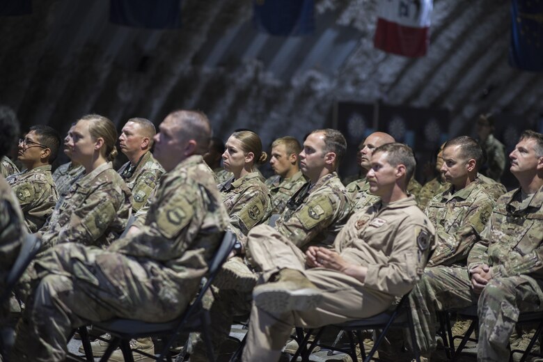 Service members attend the 332nd Expeditionary Maintenance Group change of command ceremony July 1, 2017 in Southwest Asia. The ceremony was held to recognize Col. Shane A. Barrett as the new commander of the 332nd EMXG. (U.S. Air Force photo/Senior Airman Damon Kasberg)
