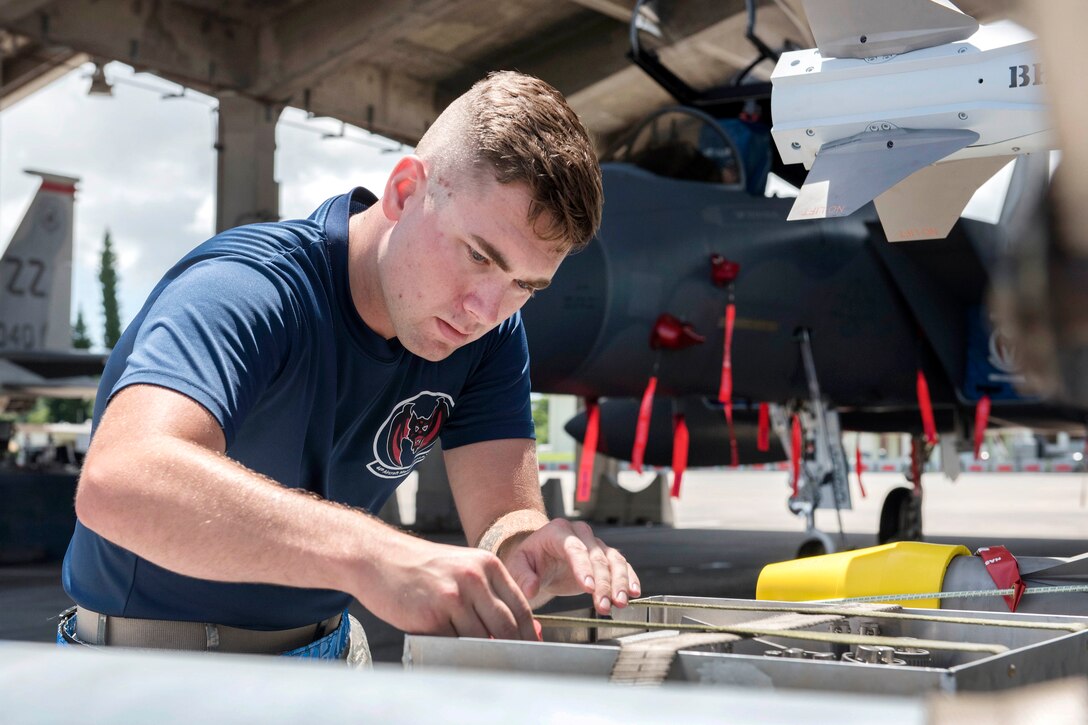 Air Force Senior Airman Jacob Clark inspects an AIM-9 Sidewinder missile during a quarterly weapons load competition at Kadena Air Base, Japan, June 23, 2017. Clark is a weapons load team crew member assigned to the 44th Aircraft Maintenance Unit. Air Force photo by Senior Airman John Linzmeier