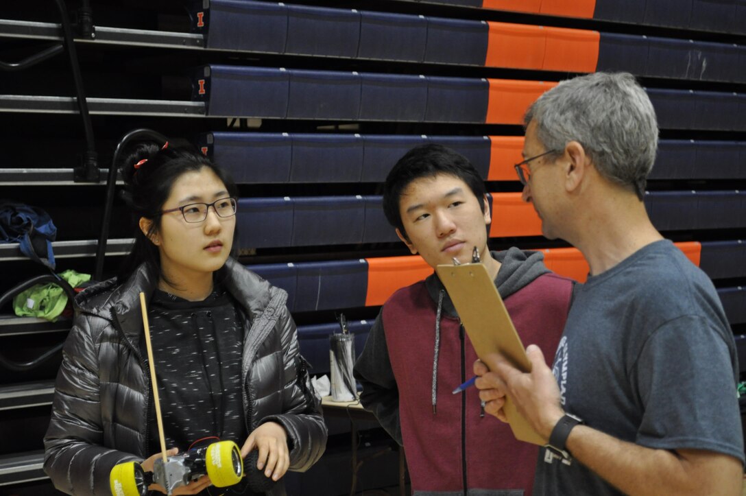Ecologist Bruce Macallister briefs two high school participants of the Electric Vehicle Competition for the Illinois Science Olympiad State Tournament on the University of Illinois Campus, Champaign-Urbana, Ill. Macallister is with the Construction Engineering Research Laboratory in Champaign.