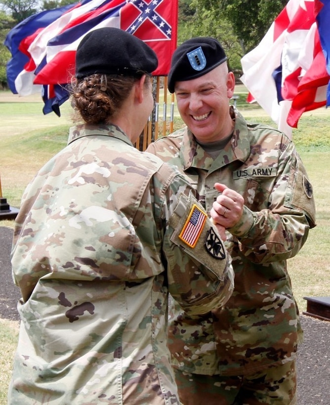 Army Chief Warrant Officer 4 Mark Parr receives a copy of the Command Chief Warrant Officer Charter from Army Maj. Gen. Susan A. Davidson, the commander of 8th Theater Sustainment Command, during a Command Chief Warrant Officer change of responsibility ceremony at Fort Shafter, Hawaii, April 6 2017. Army photo by Sgt. Jon Heinrich
