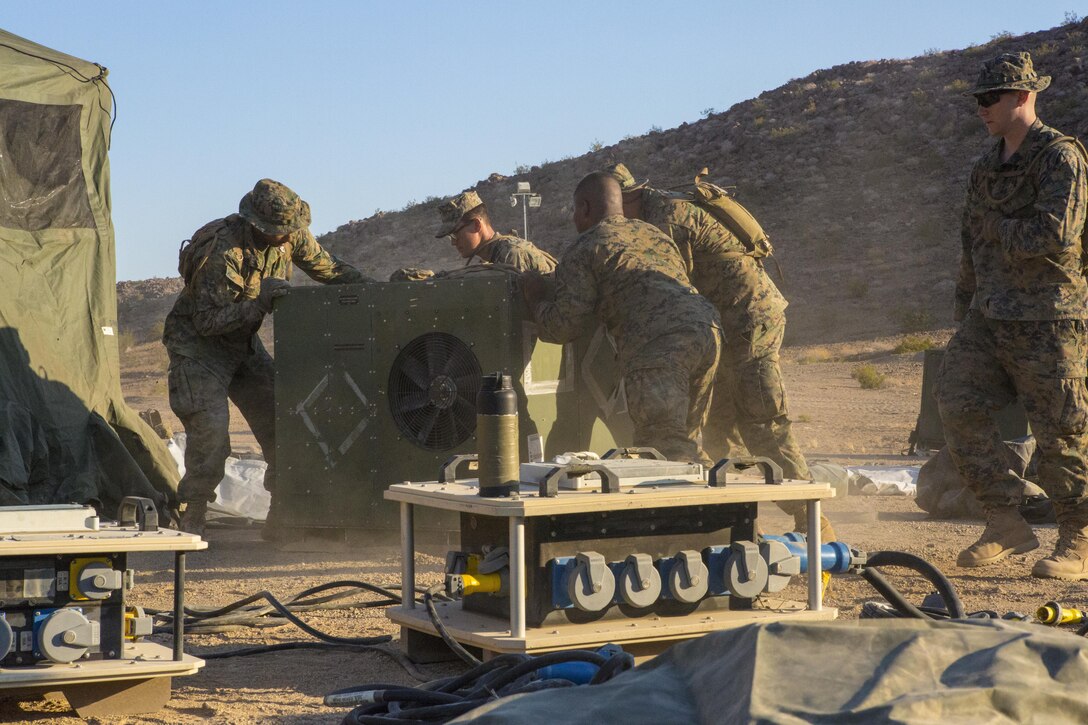 TWENTYNINE PALMS, Calif. – Marines with Combat Logistics Battalion 453, Combat Logistics Regiment 4, 4th Marine Logistics Group, Marine Forces Reserve, place air conditioners in a forward battalion aid station during Integrated Training Exercise 4-17, in Twentynine Palms, California on June 21, 2017. The Marines prepared the aid station for the 2nd Battalion, 25th Marine Regiment, 4th Marine Division, MARFORRES, final battalion exercise of Integrated Training Exercise 4-17, helping decrease the risk of heat causalities throughout the training evolution.