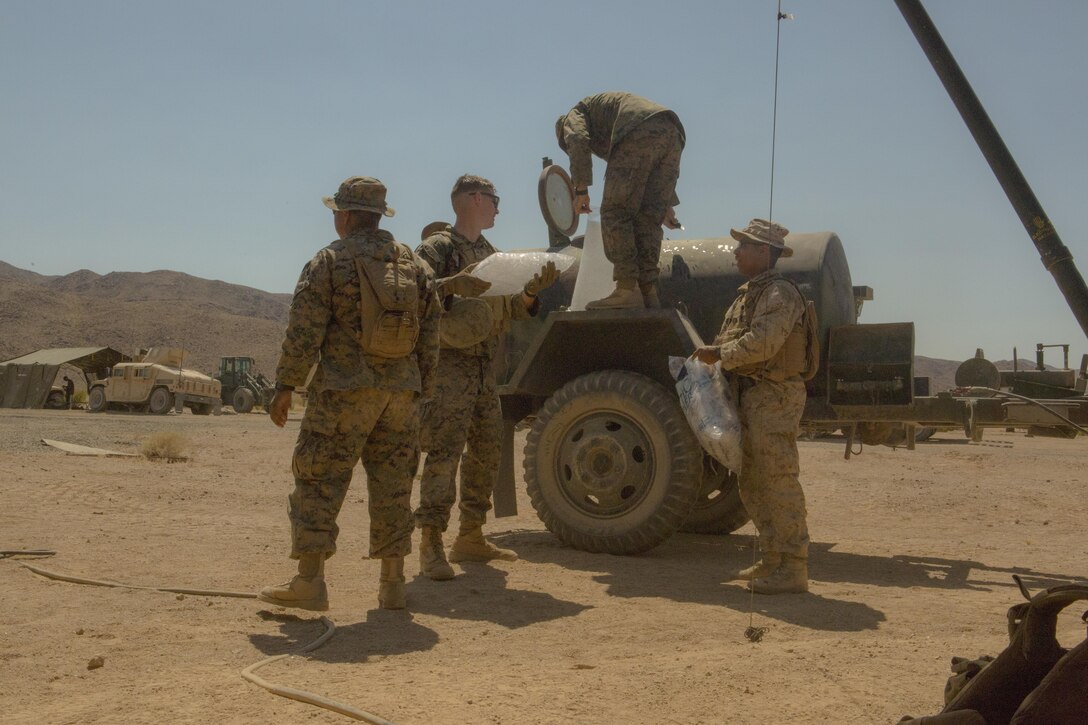 TWENTYNINE PALMS, Calif. – Marines with Combat Logistics Battalion 453, Combat Logistics Regiment 4, 4th Marine Logistics Group, Marine Forces Reserve, add ice to water supply tanks during Integrated Training Exercise 4-17 in Twentynine Palms, California, on June 22, 2017. The Marines prepared for the appearance of 2nd Battalion, 25th Marine Regiment, 4th Marine Division, MARFORRES, with ice cold water to help reduce the chance of heat casualties during the final battalion exercise of ITX 4-17.