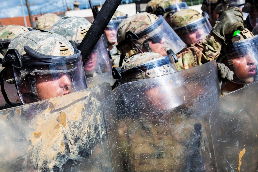 U.S. soldiers stand ready to engage simulated hostile civilians while conducting a riot control scenario during a Kosovo Force mission rehearsal exercise at the Joint Multinational Readiness Center in Hohenfels, Germany, June 30, 2017. Army photo by Spc. Randy Wren