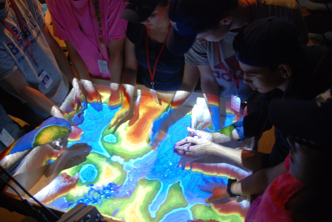 Students taking part in the SAME Camp try out the new augmented reality sandbox at ERDC's Coastal and Hydraulics Laboratory in Vicksburg June 16.