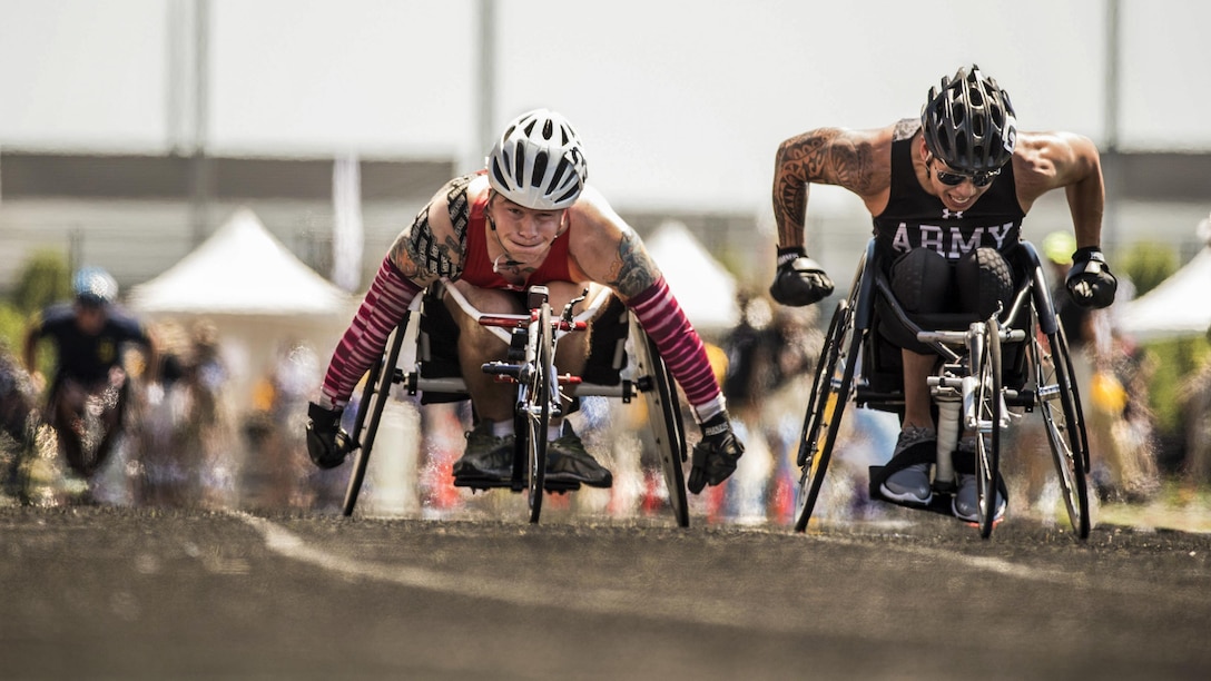 Marine Corps Cpl. Dakota Q. Boyer, left, and Army veteran Jhoonar Barrera compete in a wheelchair racing event during the 2017 Department of Defense Warrior Games in Chicago, July 2, 2017. DoD photo by Roger L. Wollenberg