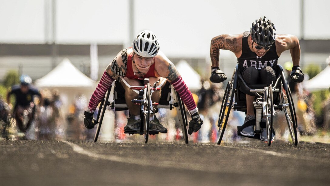 Marine Corps Cpl. Dakota Q. Boyer, left, and Army veteran Jhoonar Barrera compete in a wheelchair racing event during the 2017 Department of Defense Warrior Games in Chicago, July 2, 2017. DoD photo by Roger L. Wollenberg