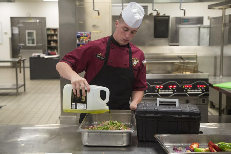 Lance Cpl. Brandon Carlson, Chef of the Quarter participant, readies chicken to be cooked for his team’s meal during the Chef of the Quarter competition at Phelps Mess Hall aboard Marine Corps Air Ground Combat Center, Twentynine Palms, Calif., June 21, 2017. The competition gave Marines and Sodexo chefs the ability to cook against each other in a friendly competition and break away from the very ridged routine schedule. (U.S. Marine Corps photo by Cpl. Thomas Mudd)