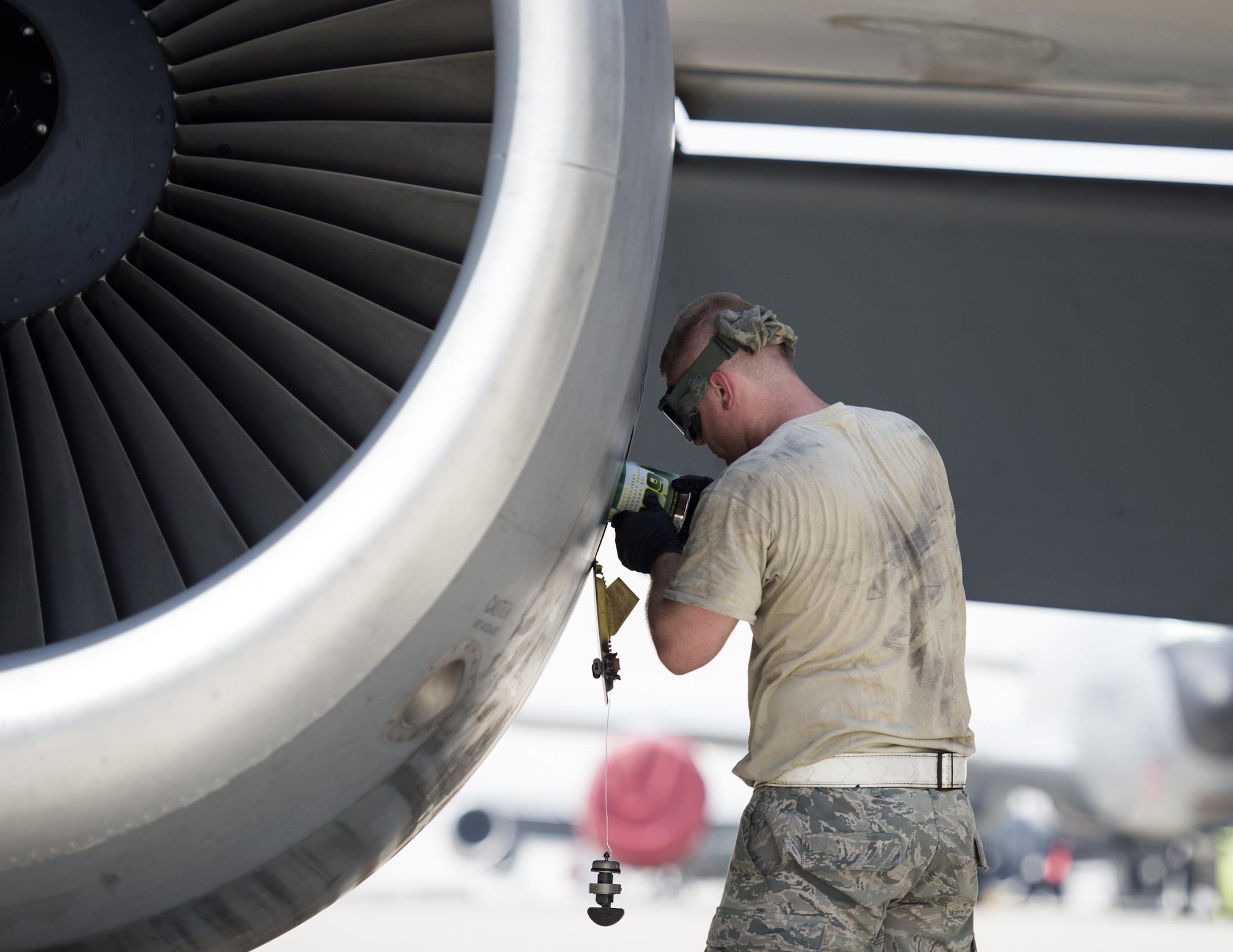 U.S Air Force crew chief with the 340th Expeditionary Aircraft Maintenance Unit places oil into an engine on a KC-135 Stratotanker at Al Udeid Air Base, Qatar, June 30, 2017.  The KC-135 Stratotanker provides aerial refueling support to U.S. and coalition aircraft 24/7 throughout the U.S. Central Command area of responsibility. (U.S. Air Force photo by Tech. Sgt. Amy M. Lovgren)