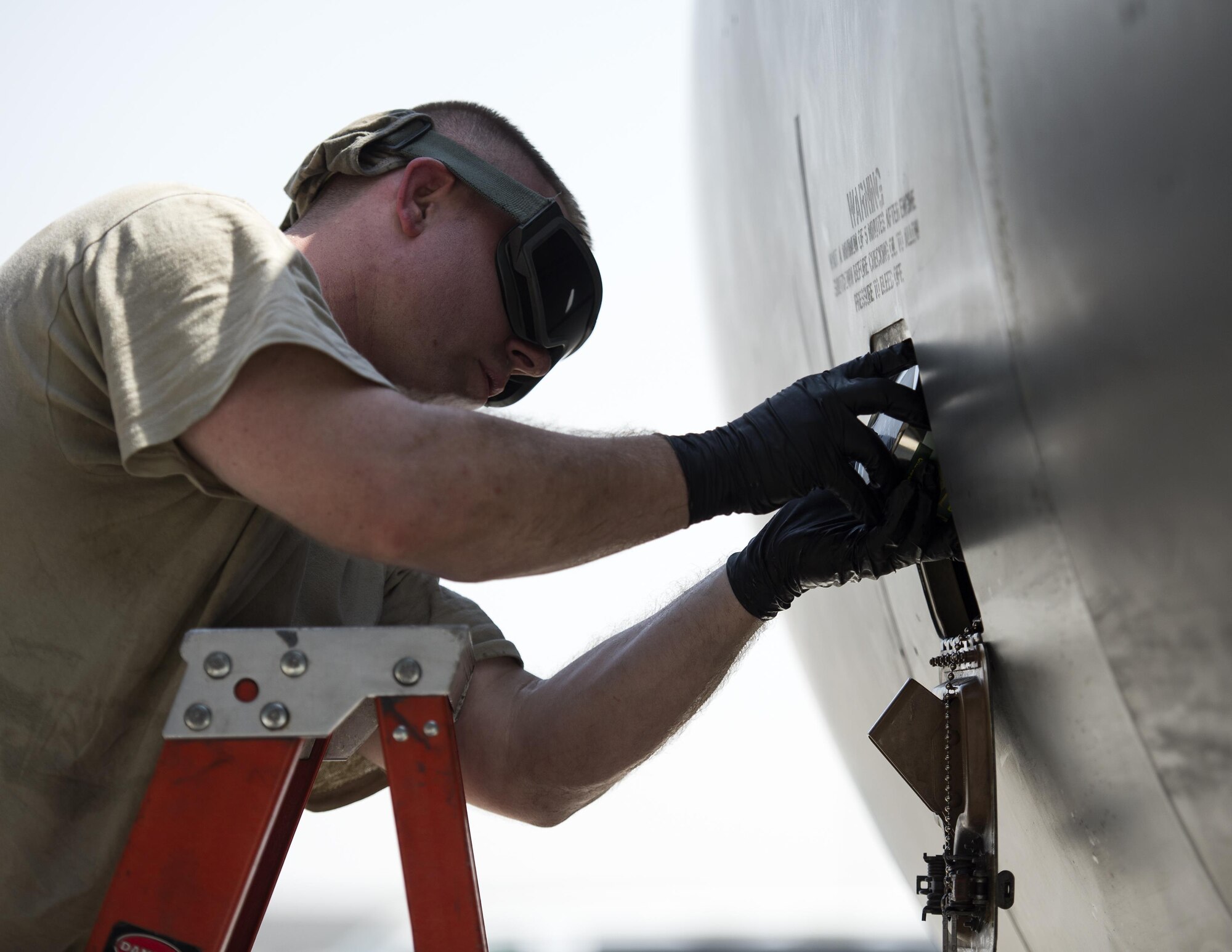 U.S Air Force crew chief with the 340th Expeditionary Aircraft Maintenance Unit places oil into an engine on a KC-135 Stratotanker at Al Udeid Air Base, Qatar, June 30, 2017.  The KC-135 Stratotanker provides aerial refueling support to U.S. and coalition aircraft 24/7 throughout the U.S. Central Command area of responsibility. (U.S. Air Force photo by Tech. Sgt. Amy M. Lovgren)