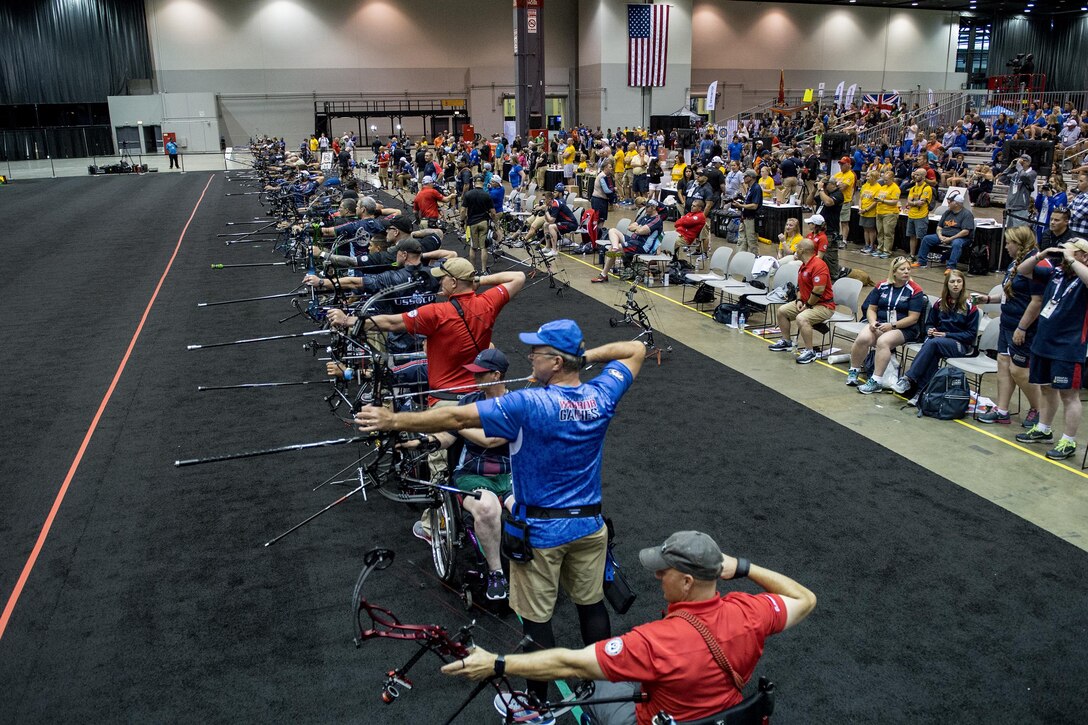 A line of archers compete in the 2017 Department of Defense Warrior Games archery competition in Chicago, July 3, 2017. The Warrior Games are an annual event allowing wounded, ill and injured service members and veterans to compete in Paralympic-style sports. DoD photo by EJ Hersom