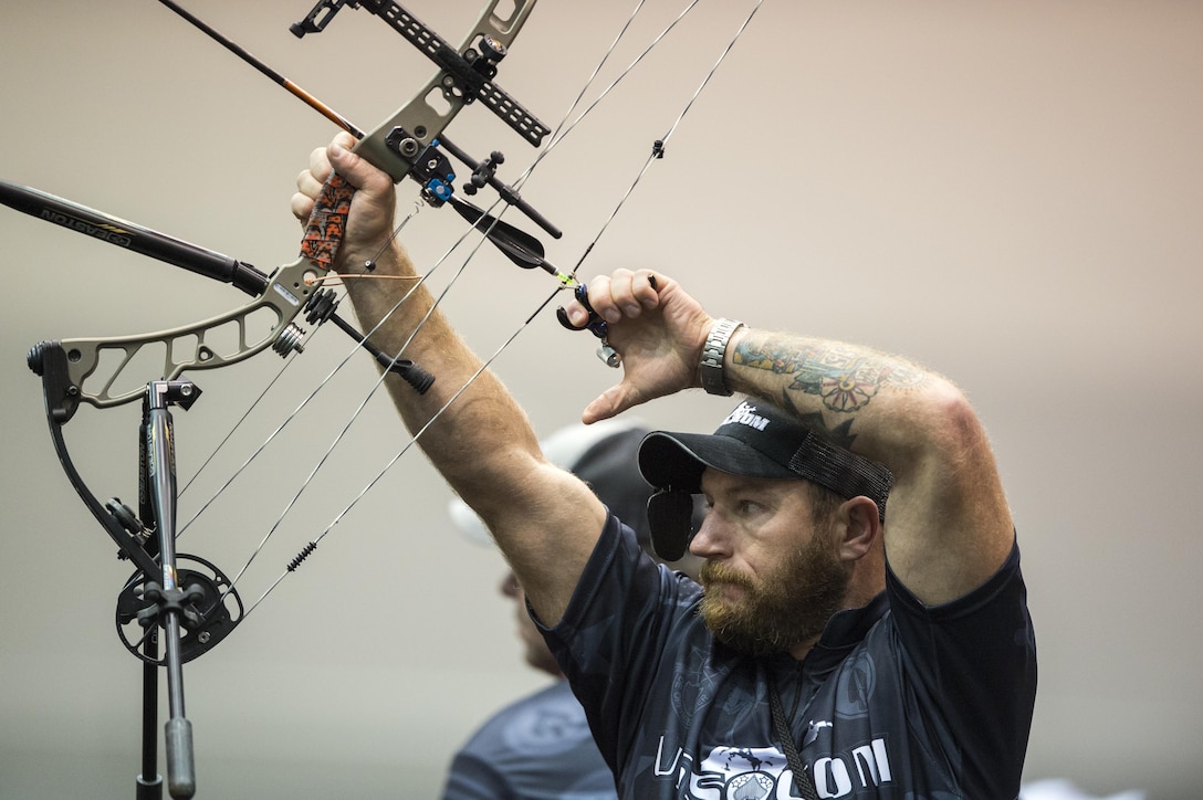 Veteran Sgt. First Class Joshua Lindstrom of Team Special Operations Command lines up his bow during the 2017 Department of Defense Warrior Games in Chicago, July 3, 2017. The DoD Warrior Games are an annual event allowing wounded, ill and injured service members and veterans to compete in Paralympic-style sports. DoD photo by EJ Hersom