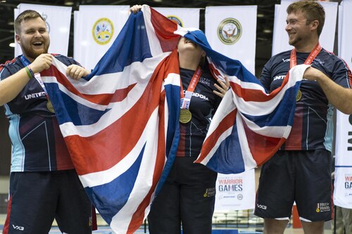 Team United Kingdom reacts to being presented the gold medal for team archery during the 2017 Department of Defense Warrior Games in Chicago, July 3, 2017. The Warrior Games are an annual event allowing wounded, ill and injured service members and veterans to compete in Paralympic-style sports. DoD photo by EJ Hersom