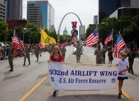 Reservist volunteers of the 932nd Airlift Wing located at Scott Air Force Base, Illinois, gave of their time to think of the history of America's Independence Day, and to consider other military veterans who went before them, those who sometimes gave the ultimate sacrifice of their lives. With the St. Louis "Gateway to the West" arch in the background, 932nd AW members and a few retirees joined in a friendly reunion to help the community celebrate America's birthday.  After an appearance on live television, they worked together to fold the American flags back into proper position at the end of their parade route. The 932nd Airlift Wing had a great group of enthusiastic volunteers who carried the Air Force Reserve name on their banner and represented the unit in the extremely popular Saint Louis parade, which was televised live on local networks, and beyond, to an estimated three million households. The wing plans to help next in the Veterans Day parade in November also.
(U.S. Air Force photo by Lt. Col. Stan Paregien)