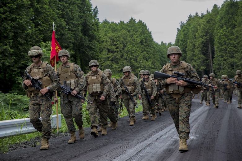 U.S. Marines attached to Marine Wine Support Squadron 171, based out of Marine Corps Air Station Iwakuni, hike back to base after completing exercise Eagle Wrath 2017 at Combined Arms Training Center Camp Fuji, Japan, June 26, 2017. Forward operating bases and forward arming and refueling points were established during the two-week exercise to train the Marines to provide explosives, weaponry, fuel, security, logistics and personnel to a forward line of troops and aircraft. The squadron is set to begin their annual weapons training on July 3, which will include training with M240B light machine guns, hand grenades, M203 grenade launchers, MK19 grenade launchers and AT-4 rocket launchers and will conclude their month-long training. 