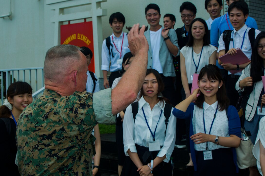 Lt. Gen. Lawrence D. Nicholson waves goodbye to approximately 30 Japanese students at the Japan-America Student Conference June 30, 2017, at III Marine Expeditionary Force Headquarters, Camp Courtney, Okinawa, Japan. The Japan-America Student Conference is an educational and cultural exchange program for university students. Nicholson spoke with the students to discuss the purpose of military presence in Okinawa, the Japan-American alliance and Japan’s continuing partnership with the United States. Nicholson is the III Marine Expeditionary Force commanding general and the Okinawa Area Coordinator. (U.S. Marine Corps photo by Lance Cpl. Andrew Neumann) 