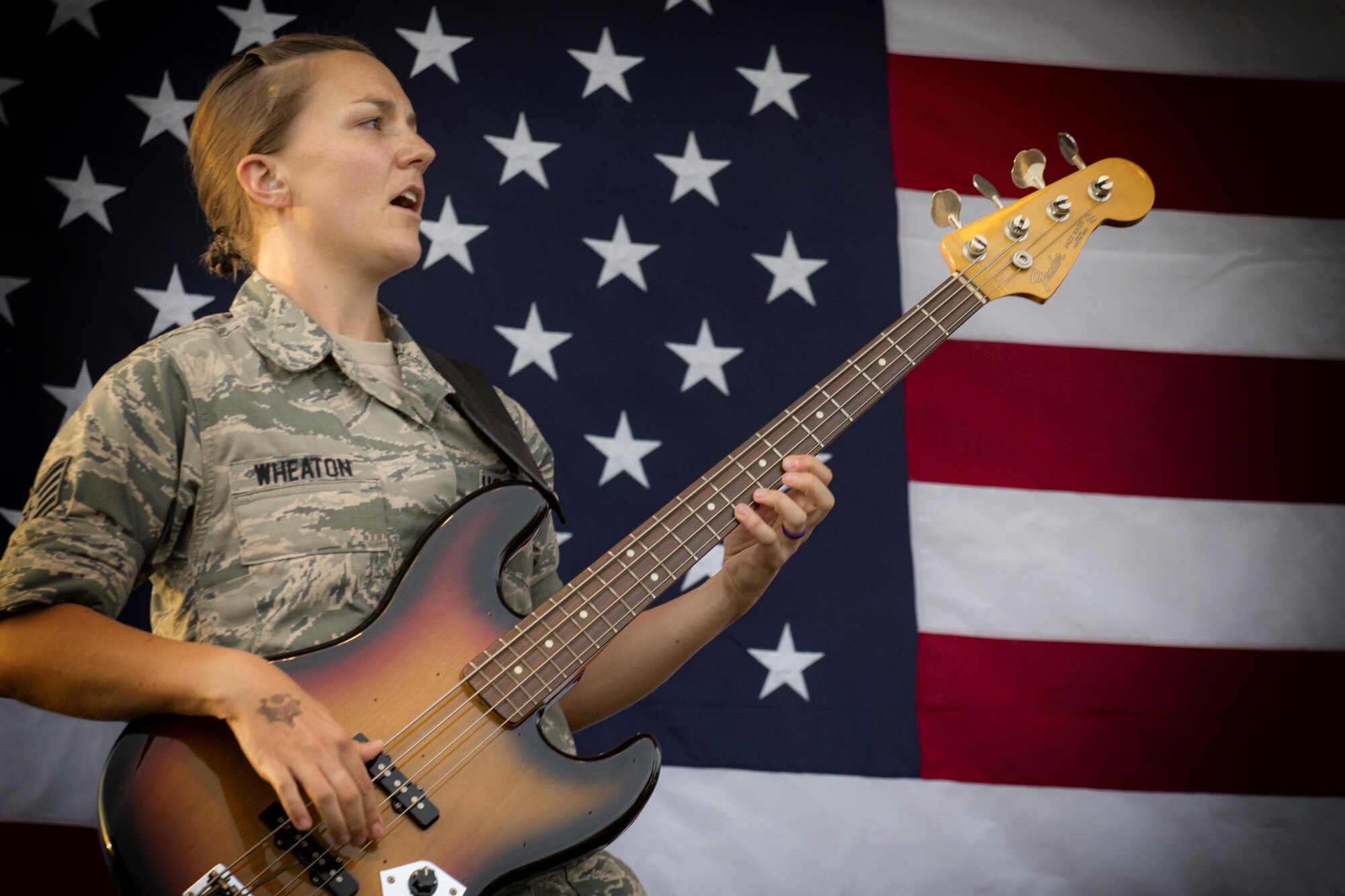 Staff Sgt. Emily Wheaton, Pacific Air Force Band member, plays a guitar during a concert at the Celebrate America festival on Yokota Air Base, Japan, June 30, 2017. The day kicked off with the firecracker 5K run and a wide variety of activities to include a petting zoo, dance performaces, food and fireworks. (U.S. Air Force photo by Staff Sgt. David Owsianka)