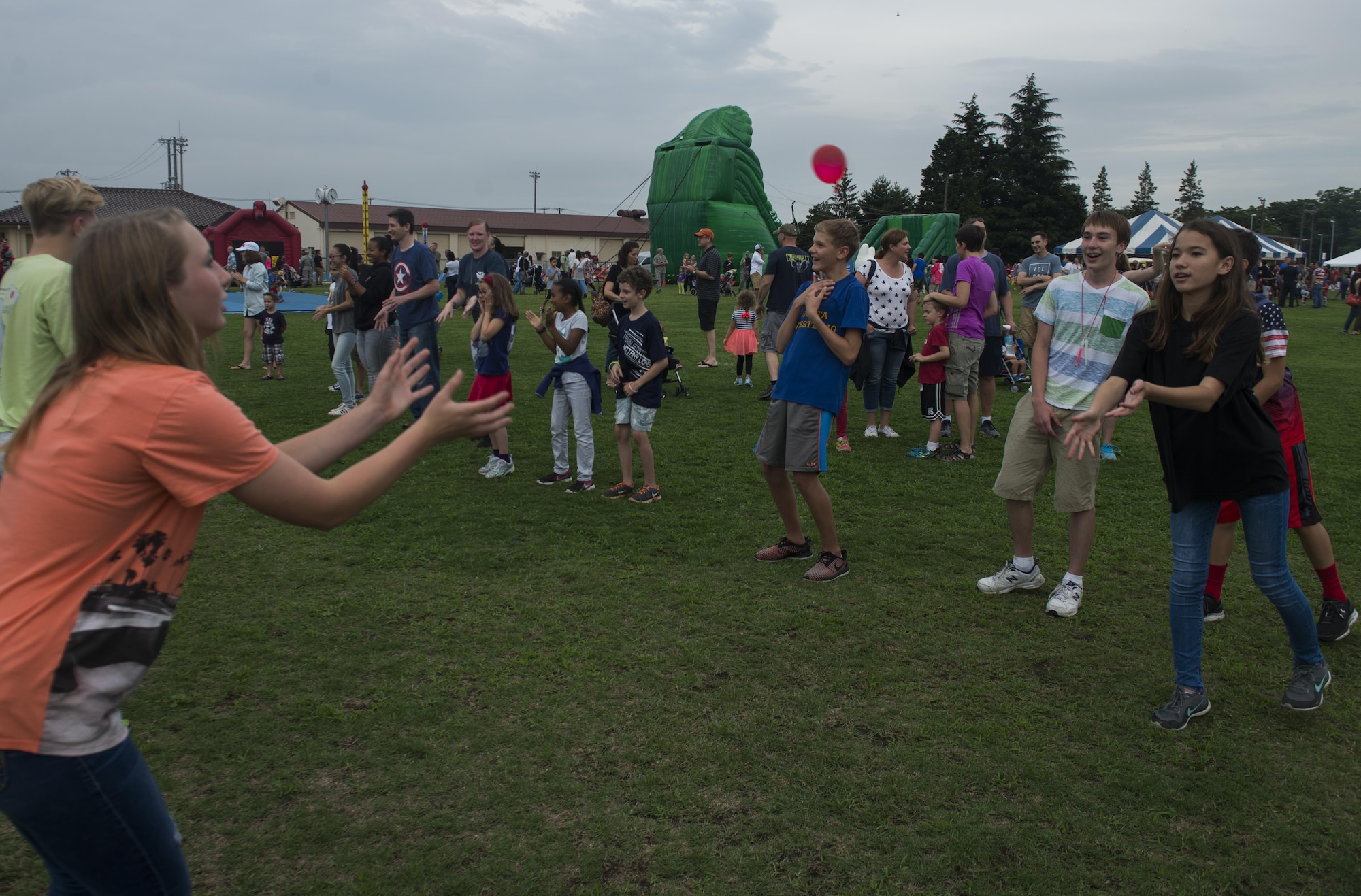 Kids toss water baloons during a competition at the Celebrate America festival on Yokota Air Base, Japan, June 30, 2017. The annual event is hosted to celebrate America's Indepence Day and enhance espirit de corps. (U.S. Air Force photo by Staff Sgt. David Owsianka)