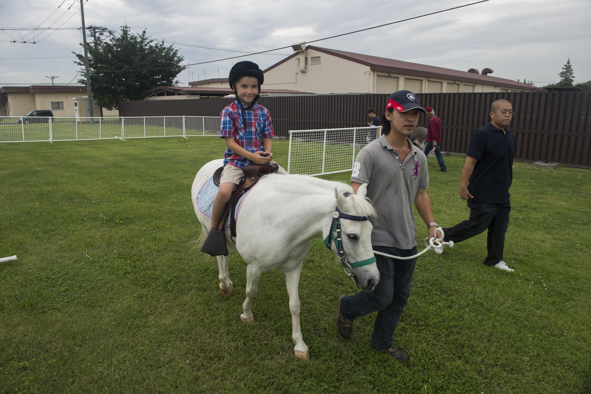 Jaxson Buum, 7, son of Tech. Sgt. Anthony Buum, 374th Aircraft Maintenance Squadron, rides a pony during the Celebrate America festival at Yokota Air Base, Japan, June 30, 2017.  The event provided military members and their families the opprotunity to enjoy games, food and bands before culminating in a fireworks display to celebrate Indepence Day. (U.S. Air Force photo by Staff Sgt. David Owsianka)