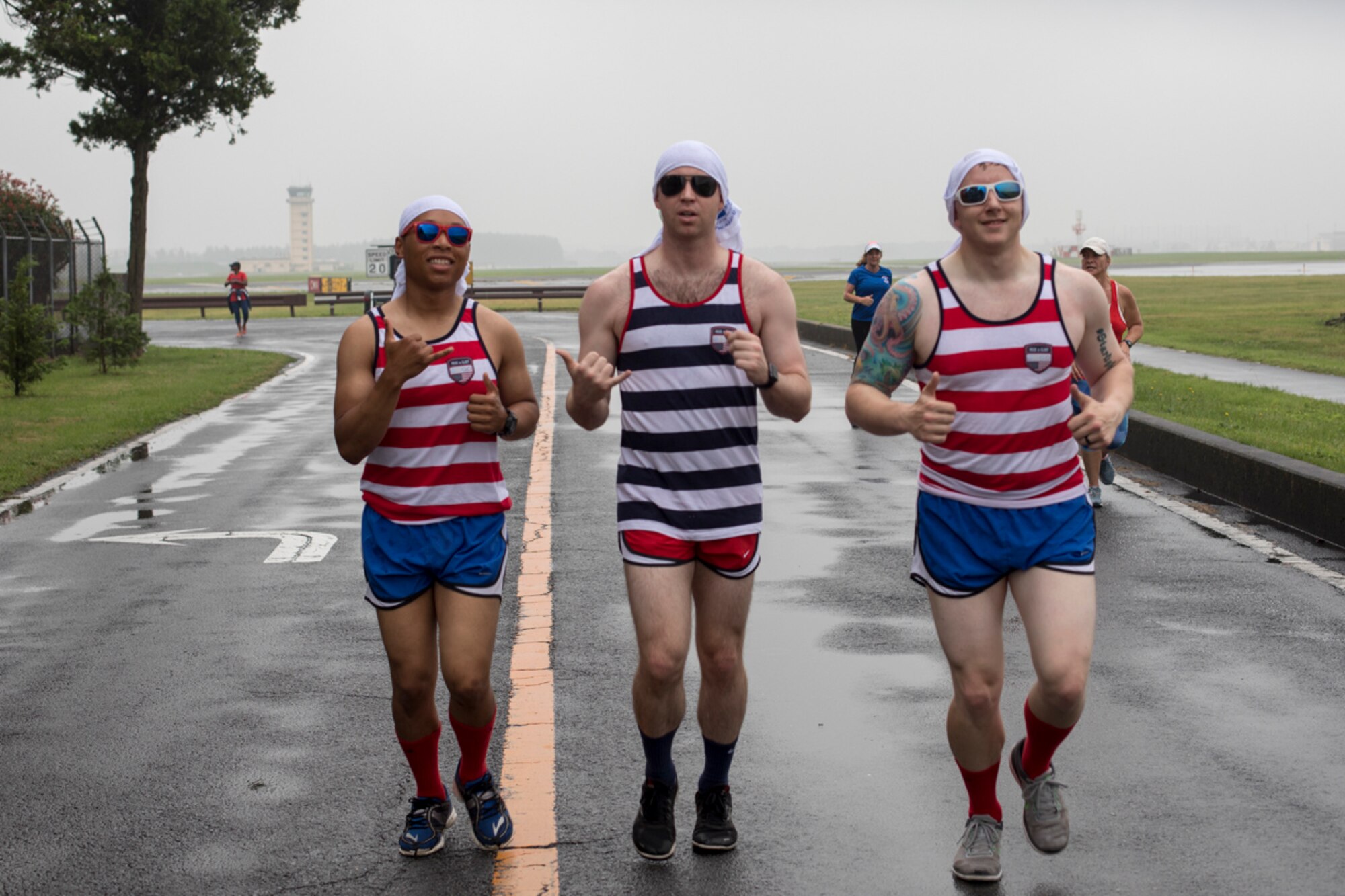 Airmen jog along the trail of the Firecracker 5K run, during the Celebrate America, June 30, 2017. Celebrate America provided Yokota personnel and their families the opportunity to relax and strengthen camaraderie while remembering America's independence. (U.S. Air Force photo by Yasuo Osakabe)