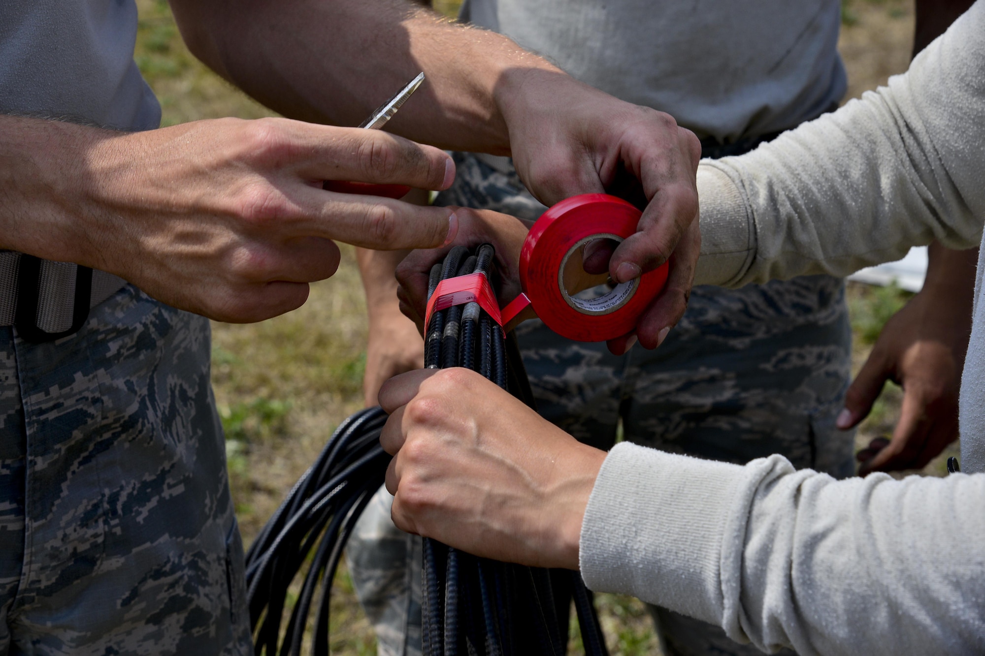 The 51st Operations Support Squadron Air Traffic Control Airfield Landing Systems personnel tape a cable at Osan Air Base, Republic of Korea, June 22, 2017. Members of Team Osan’s 51st OSS and 51st Civil Engineer Squadron worked together to move an instrument landing system from the recently closed runway to the newly repaired runway. (U.S. Air Force photo by Airman 1st Class Gwendalyn Smith)