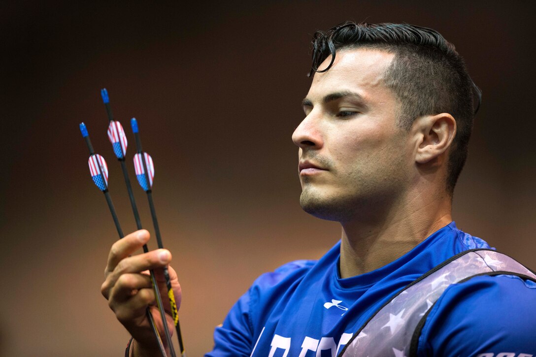 Air Force Staff Sgt. Vincent Cavazos inspects his arrows after making it into the archery finals during the 2017 Department of Defense Warrior Games in Chicago, July 3, 2017. DoD photo by EJ Hersom