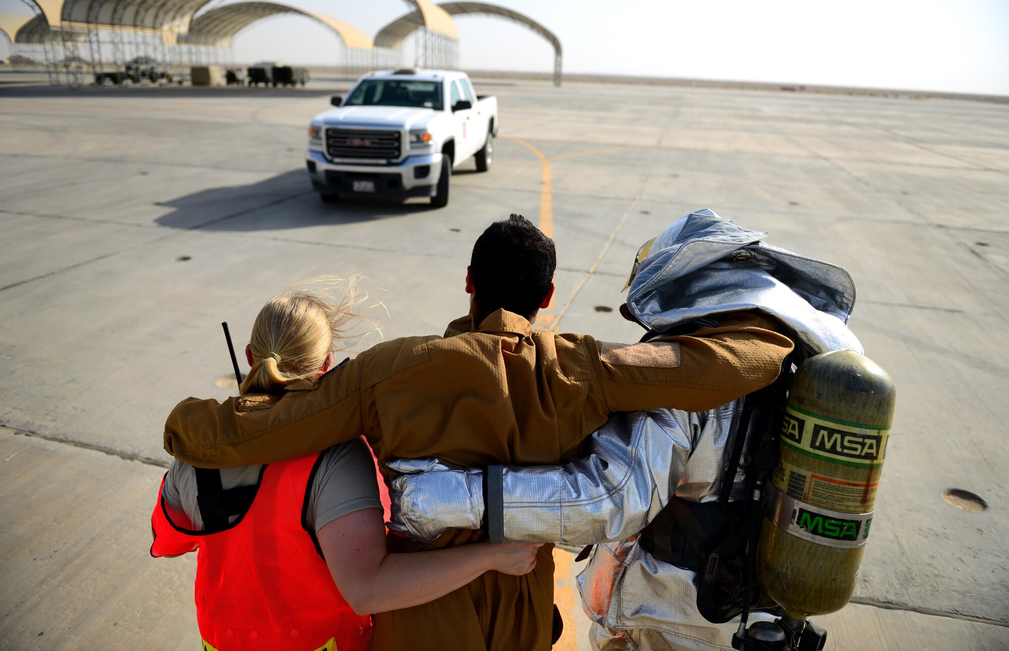 U.S. Air Force fire fighters assigned to the 407th Expeditionary Civil Engineer Squadron, remove injured Italian Air Force crew members during a simulated in-flight emergency call during a flight in Southwest Asia on July 2, 2017. The 407th ECES fire department operate as first responders to all U.S. and coalition aircraft in the area of responsibility. (U.S. Air Force photo by Tech Sgt. Andy M. Kin)