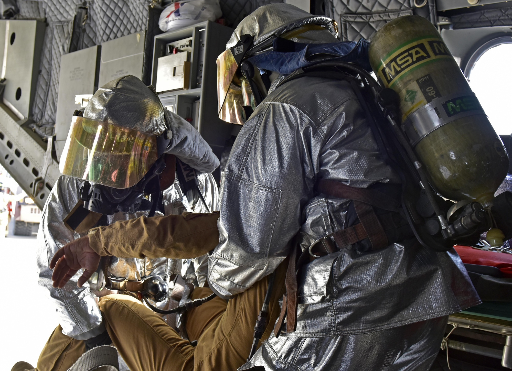 407th Expeditionary Civil Engineer Squadron fire department members carry an Italin Air Force service member off a simulated mulfunctioned aircraft during a joint coalition exercise with U.S. Air Force  and Italian Air Force July 2, 2017, at the 407th Air Expeditionary Group in Southwest Asia. The exercise was a constructed as an in flight emergency, which the first responders task was to secure the area, determine safe for entry and then recover injured aircrew. (U.S. Air Force photo by Senior Airman Ramon A. Adelan)