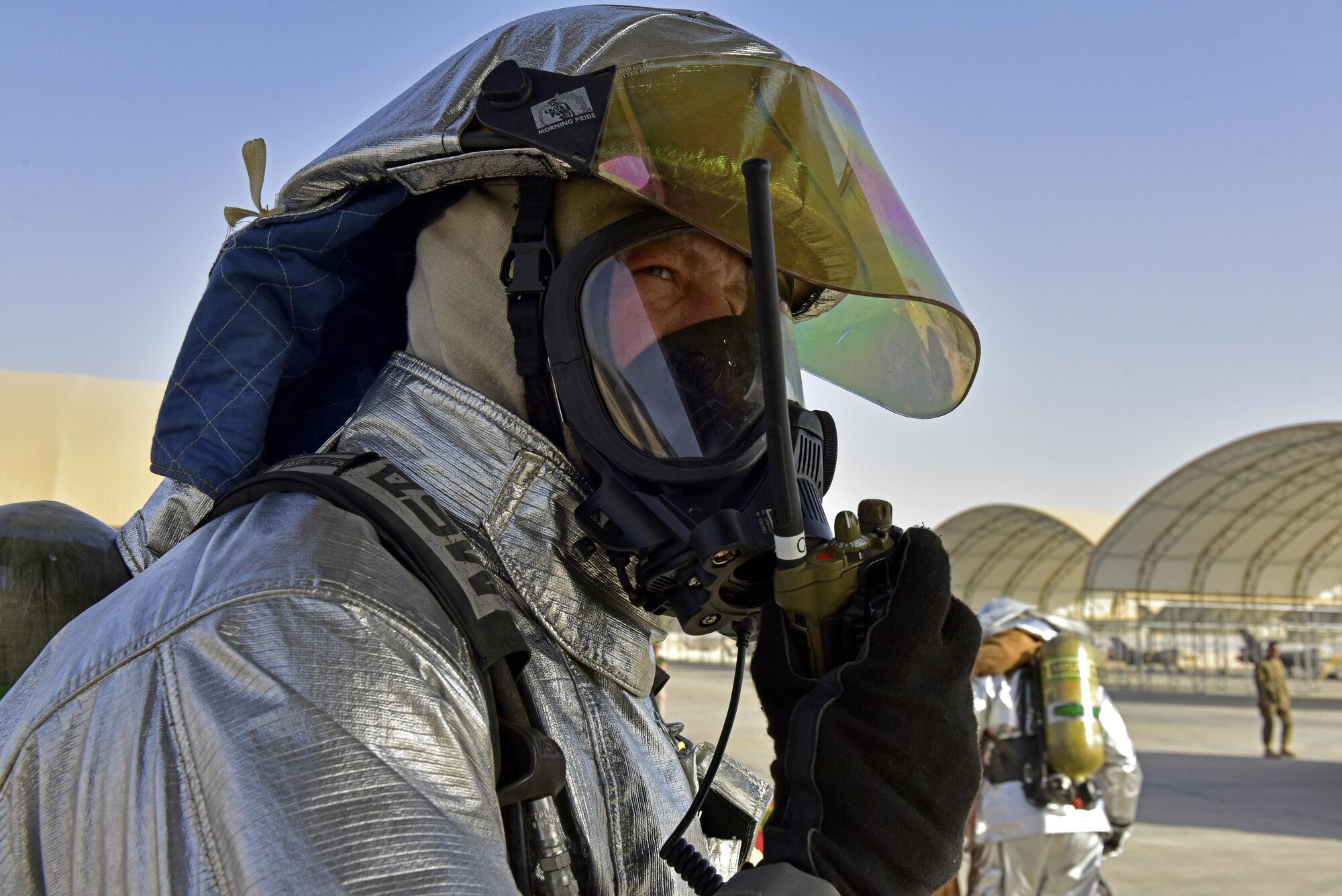 A 407th Expeditionary Civil Engineer Squadron fire department member communicates with the on scene commander during a joint coalition exercise with U.S. Air Force  and Italian Air Force July 2, 2017, at the 407th Air Expeditionary Group in Southwest Asia. The exercise was a constructed as an in flight emergency, which the first responders task was to respond to a simulated malfunctioned aircraft, secure the area, determine safe for entry and then recover injured aircrew. (U.S. Air Force photo by Senior Airman Ramon A. Adelan)