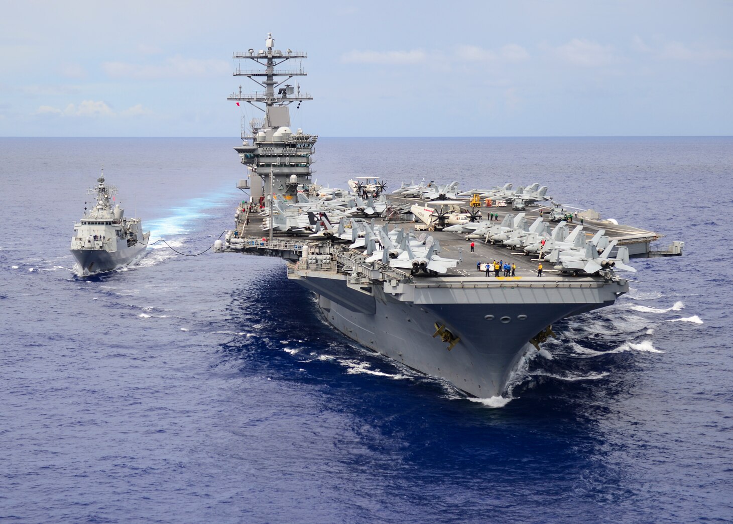 PHILIPPINE SEA (July 2, 2017) The aircraft carrier USS Nimitz (CVN 68) conducts a replenishment-at-sea with the Royal New Zealand Navy Anzac-class frigate HMNZS Te Kaha (F77), July 2, 2017, in the Philippine Sea. Sailors from HMNZS Te Kaha (F77) and Carrier Strike Group (CSG) 11 are conducting a series of bilateral training operations designed to increase interoperability and readiness.