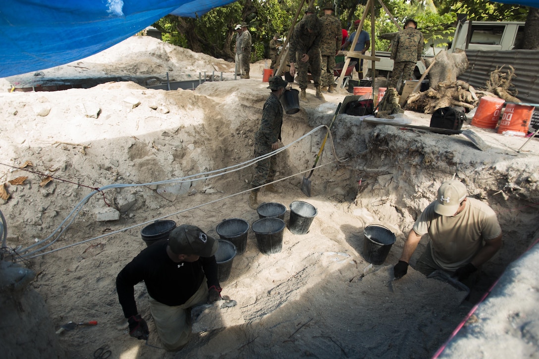 Marines and Sailors with Task Force Koa Moana 17 transport dirt in order to assist an archaeological team at a World War II mass grave excavation, June 13, 2017, in Betio Island, Tarawa Atoll, Kiribati. The Marines and Sailors that assisted were unable to work with the fragile bones of the deceased, so they assisted with back-filling holes and transporting dirt.  No photos of the remains were taken in order to respect the deceased and their families.