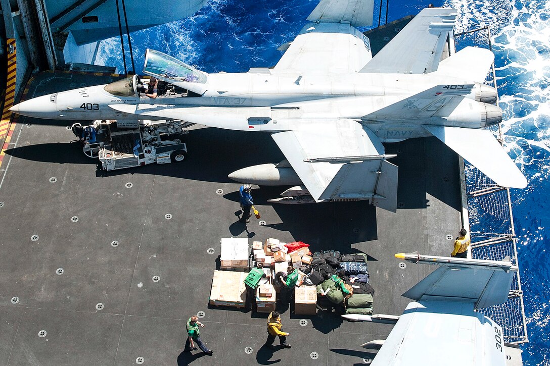Sailors move luggage and mail aboard the aircraft carrier USS George H.W. Bush in the Mediterranean Sea, June 25, 2017. The George H.W. Bush Carrier Strike Group is conducting naval operations in the U.S. 6th Fleet area of operations to support U.S. national security interests in Europe and Africa. Navy photo by Petty Officer 3rd Class Mario Coto