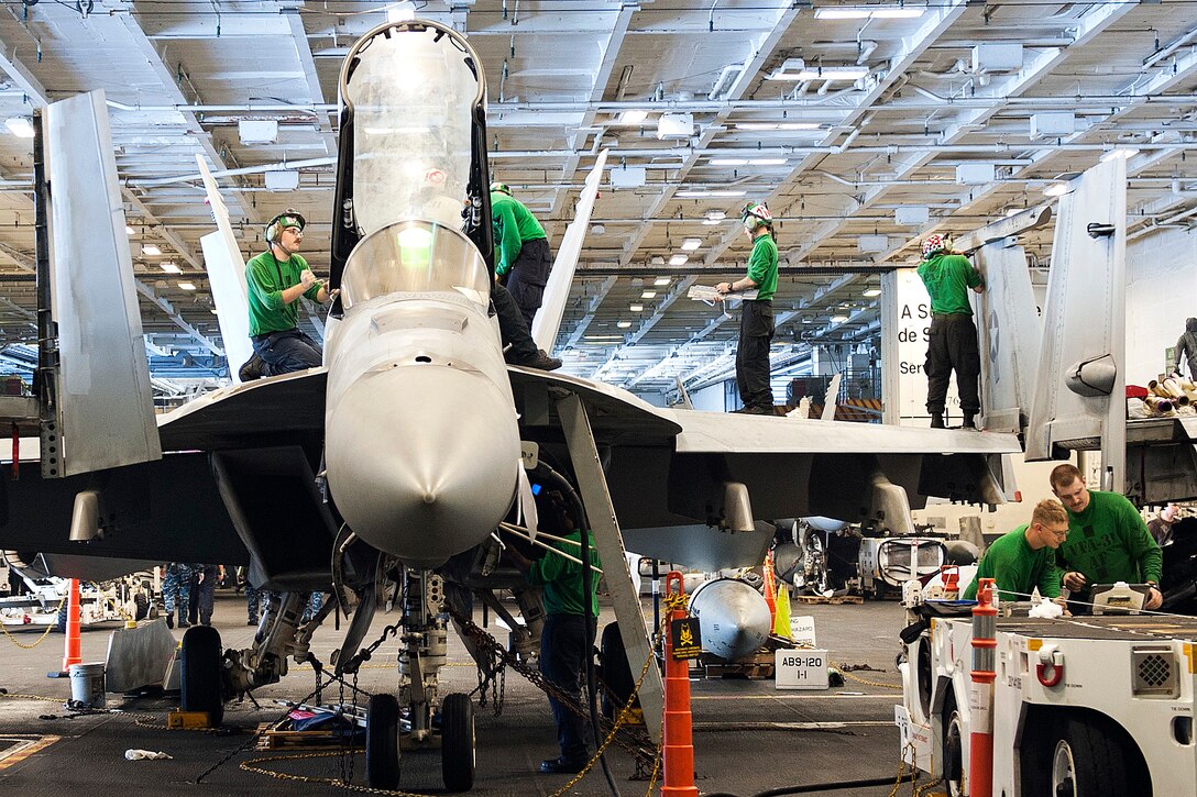 Sailors conduct maintenance of an F/A-18E Super Hornet aboard the aircraft carrier USS George H.W. Bush in the Mediterranean Sea, June 25, 2017. Navy photo by Petty Officer 3rd Class Mario Coto