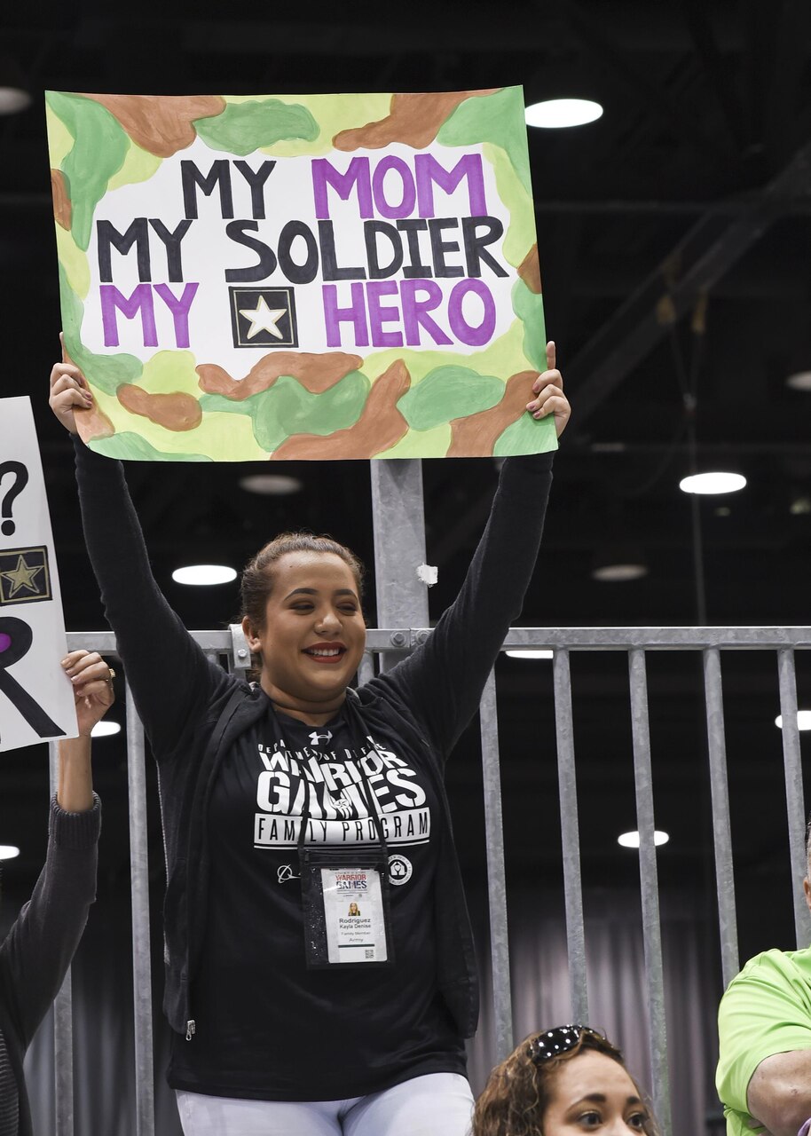 Kayla Rodriguez cheers for her mother, Michelle Sanchez, during the archery competition for the 2017 Department of Defense Warrior Games at McCormick Place in Chicago, July 3, 2017. Navy photo by Seaman Perla Landa