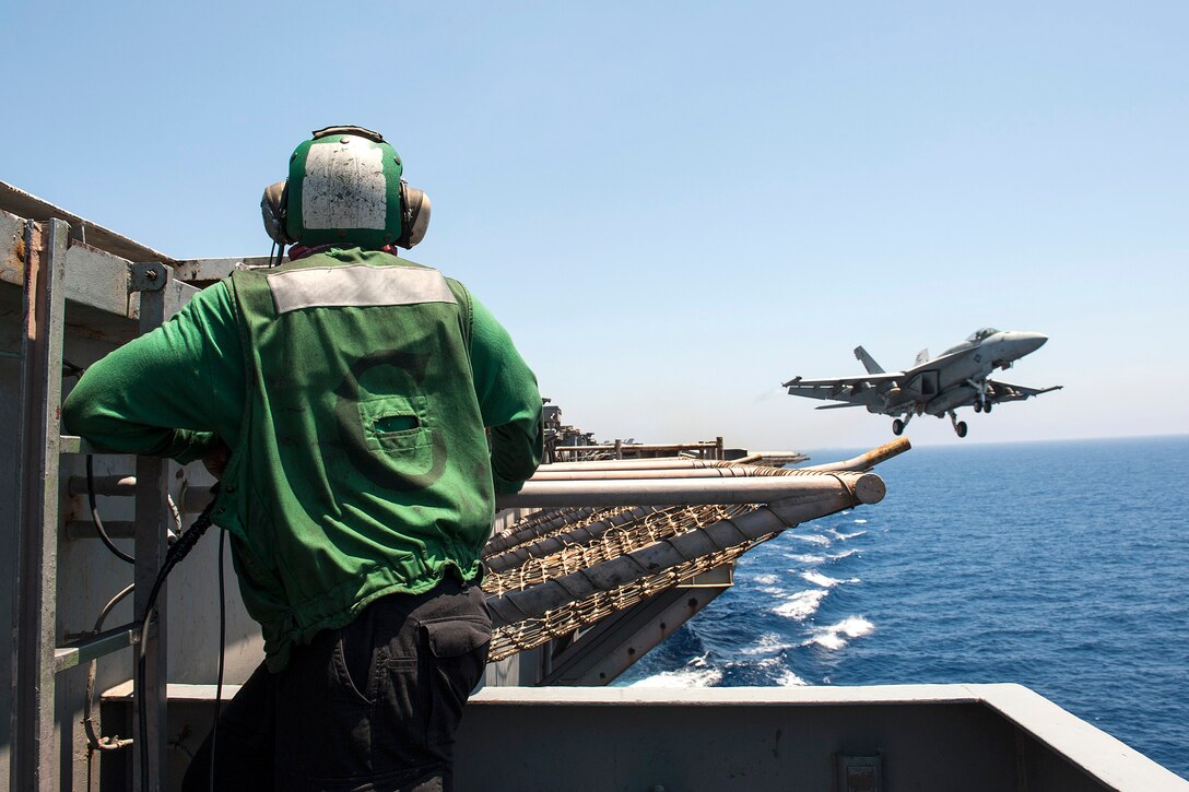 Navy Seaman James Johnson observes flight operations while standing watch aboard the aircraft carrier USS George H.W. Bush in the Mediterranean Sea, June 26, 2017. Johnson is an aviation boatswain's mate. Navy photo by Seaman Jennifer M. Kirkman