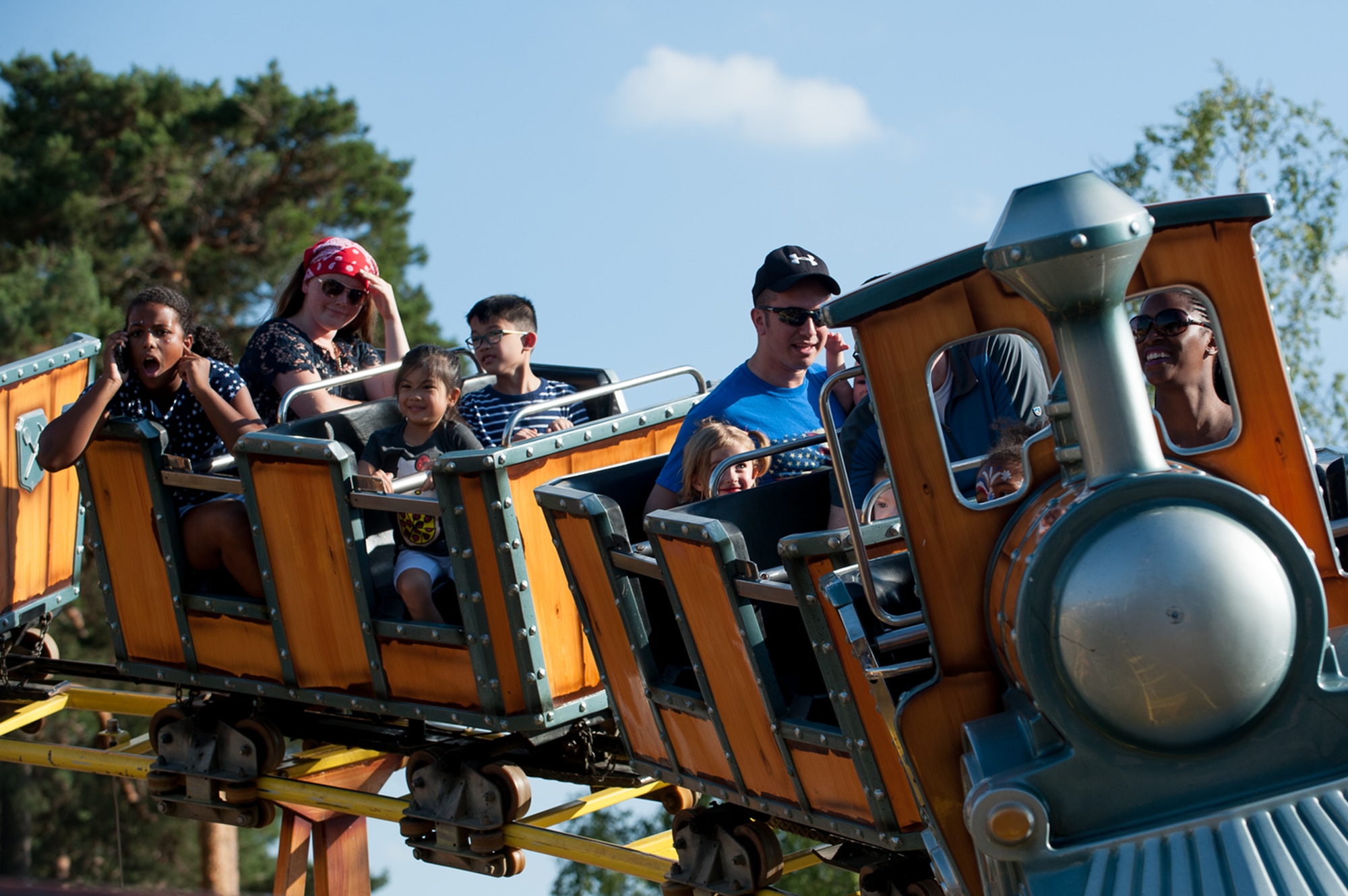 A Kaiserslautern Military Community member talks on her phone while riding a carnival coaster with other KMC members during Freedom Fest at the Enlisted Club parking lot on Ramstein Air Base, Germany, July 4, 2017. Thousands of people gathered for the festivities to celebrate Independence Day, the day the Continental Congress declared the 13 American colonies as a new nation and no longer a part of the British Empire in 1776. (U.S. Air Force photo by Senior Airman Devin Boyer)