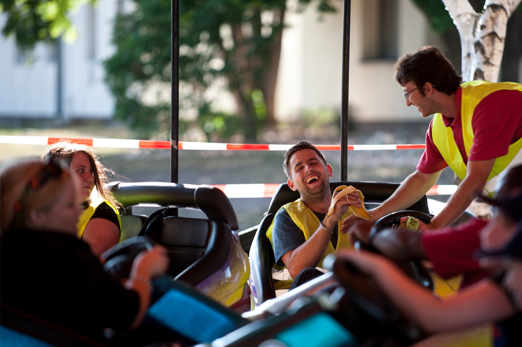 A carnival ride attendant eats a banana while testing a bumper car during Freedom Fest at the Enlisted Club parking lot on Ramstein Air Base, Germany, July 4, 2017. Kaiserslautern Military Community members could enjoy the rides throughout the day into the evening when the event concluded with a fireworks display. (U.S. Air Force photo by Senior Airman Devin Boyer)