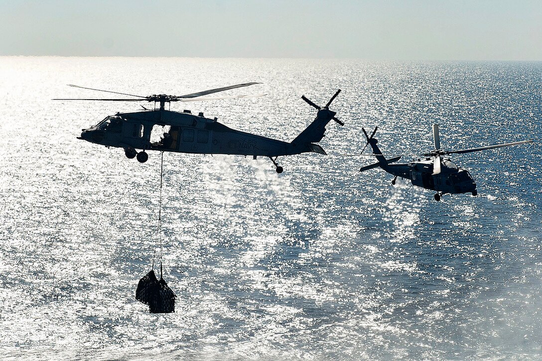 An MH-60S Seahawk helicopter transports supplies to the aircraft carrier USS George H.W. Bush in the Mediterranean Sea, June 28, 2017. Navy photo by Petty Officer 3rd Class Mario Coto